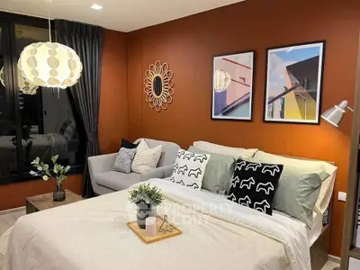 Stylish bedroom with modern decor and cozy seating area