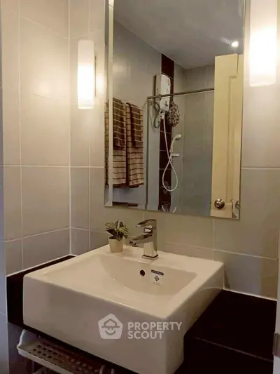 Modern bathroom with sleek sink and shower area