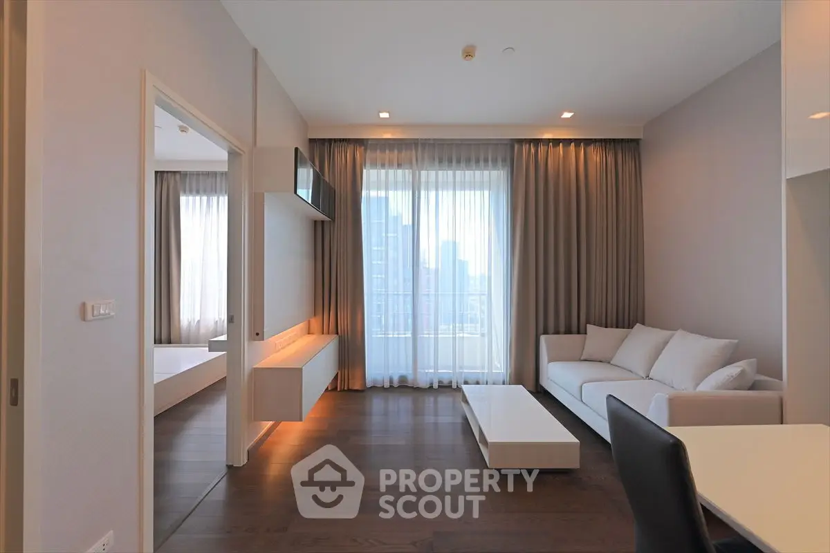 Modern living room with elegant decor and large windows offering city views