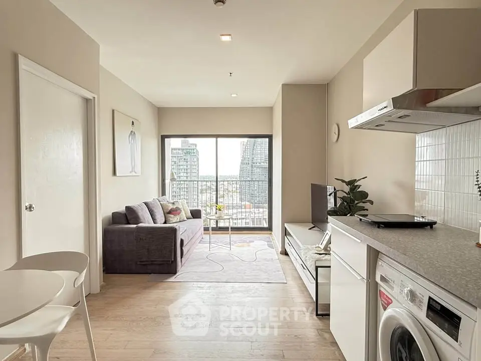 Modern living room with open kitchen and city view balcony in high-rise apartment.