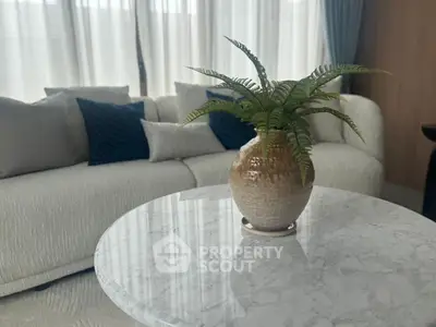 Elegant living room with marble table and stylish sofa, perfect for modern living.