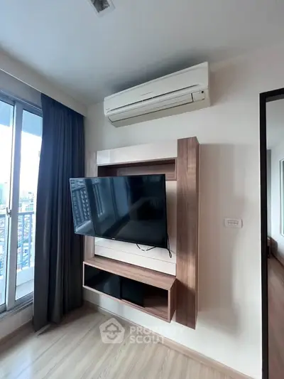 Modern living room with wall-mounted TV and air conditioning, featuring a sleek design and city view.