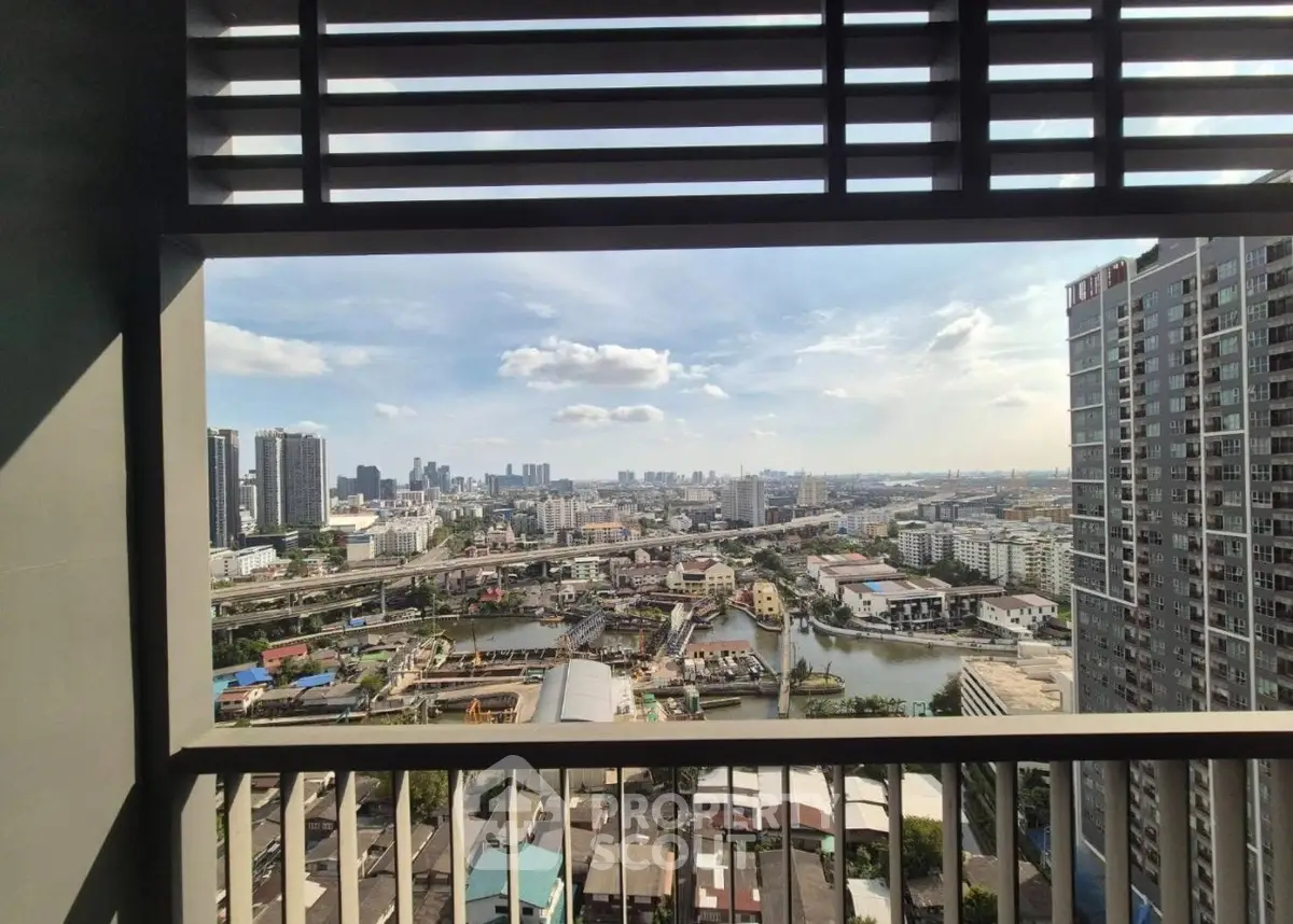 Stunning cityscape view from high-rise balcony with urban skyline and river.