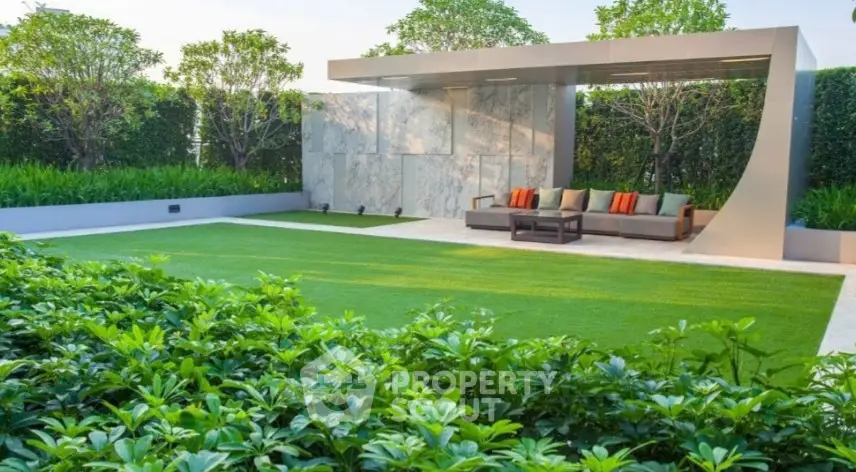 Luxurious garden with modern seating area and lush greenery, perfect for relaxation and outdoor gatherings.