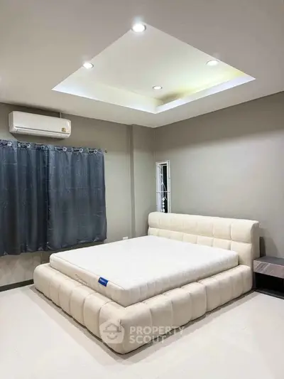 Spacious bedroom with modern design and plush bed in a cozy setting.