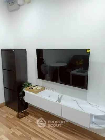 Modern living room with sleek TV setup and stylish storage solutions.