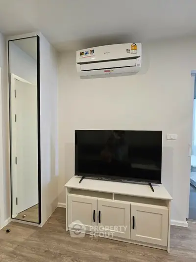 Modern living room with air conditioning and sleek TV setup