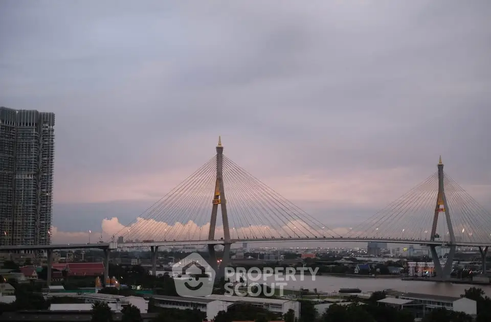 Stunning cityscape view featuring a modern suspension bridge at dusk, perfect for urban living enthusiasts.