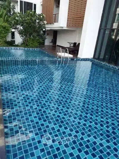 Luxurious residential pool with modern design and serene surroundings.