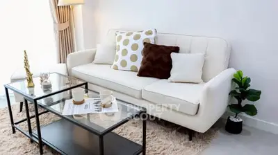 Stylish modern living room with elegant sofa and glass coffee table