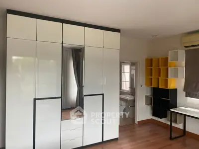 Spacious bedroom with modern wardrobe and study area