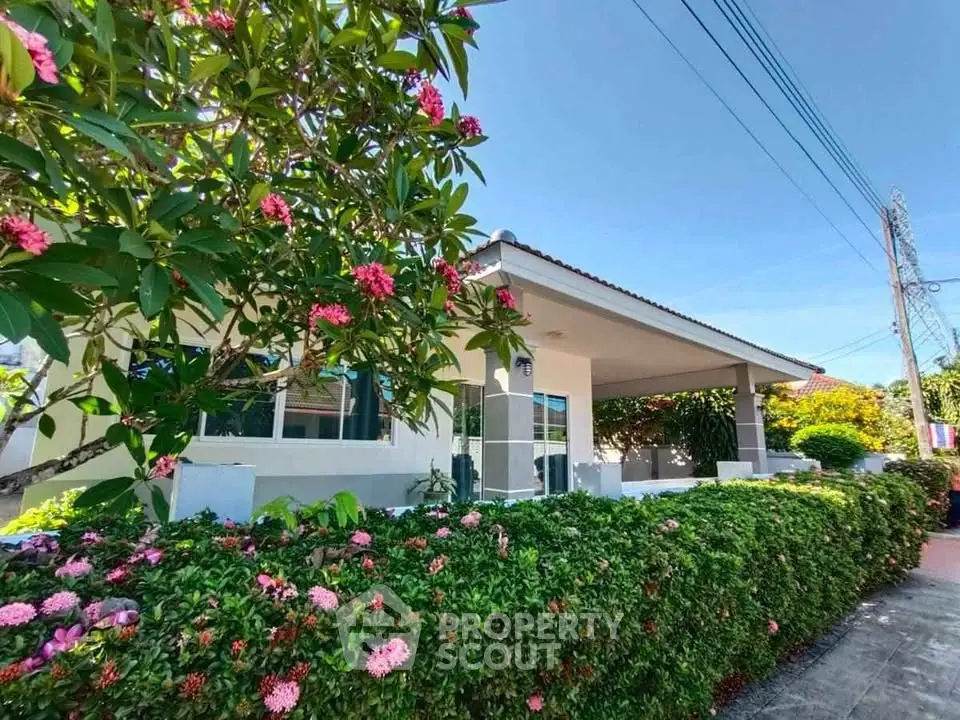Charming suburban house with lush garden and vibrant flowers, perfect for tranquil living.