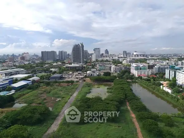 Stunning aerial view of urban landscape with lush greenery and modern skyline, perfect for real estate investment.