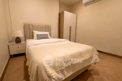 Cozy bedroom with modern furnishings and warm lighting, perfect for relaxation and comfort.