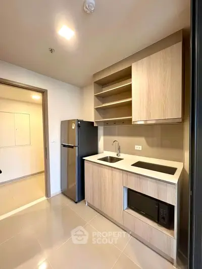 Modern kitchen with sleek cabinetry and built-in appliances in a stylish apartment.