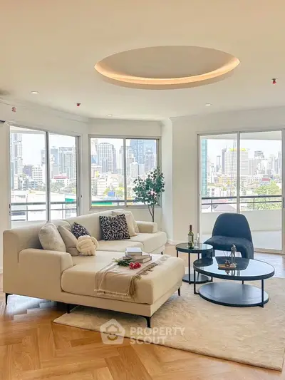 Spacious living room with city view, modern furniture, and elegant decor in a high-rise apartment.