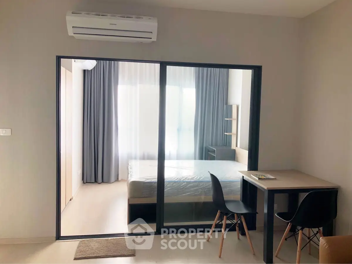 Modern bedroom with glass partition and air conditioning in stylish apartment