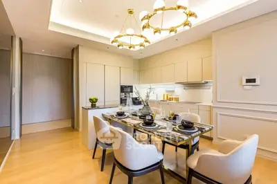 Luxurious dining area with elegant lighting and modern kitchen in open layout