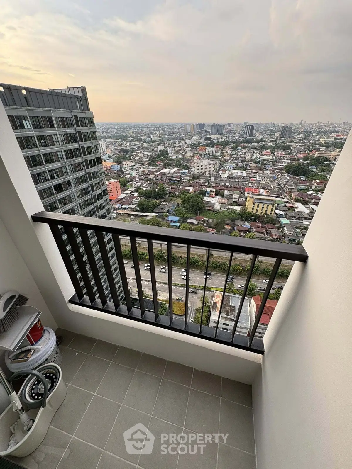 Stunning high-rise balcony view overlooking cityscape, perfect for urban living enthusiasts.