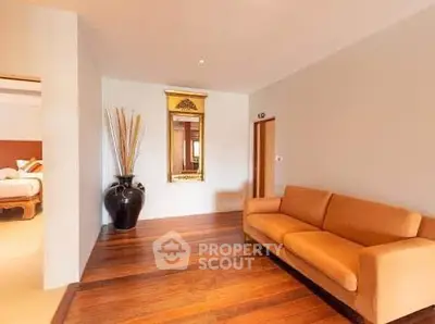 Spacious living room with elegant wooden flooring and stylish decor