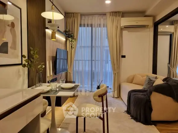 Modern living room with elegant decor, featuring a cozy sofa, dining area, and wall-mounted TV.