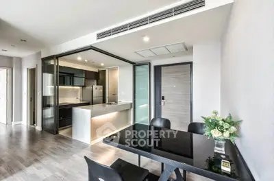 Modern open-plan kitchen and dining area with sleek design and natural light.
