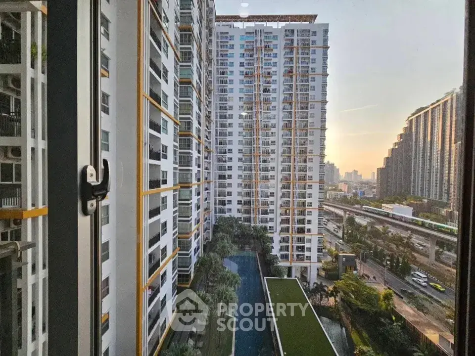 Stunning high-rise apartment view with pool and cityscape, perfect for urban living.