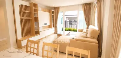 Spacious modern living room with elegant furniture and large windows for natural light.