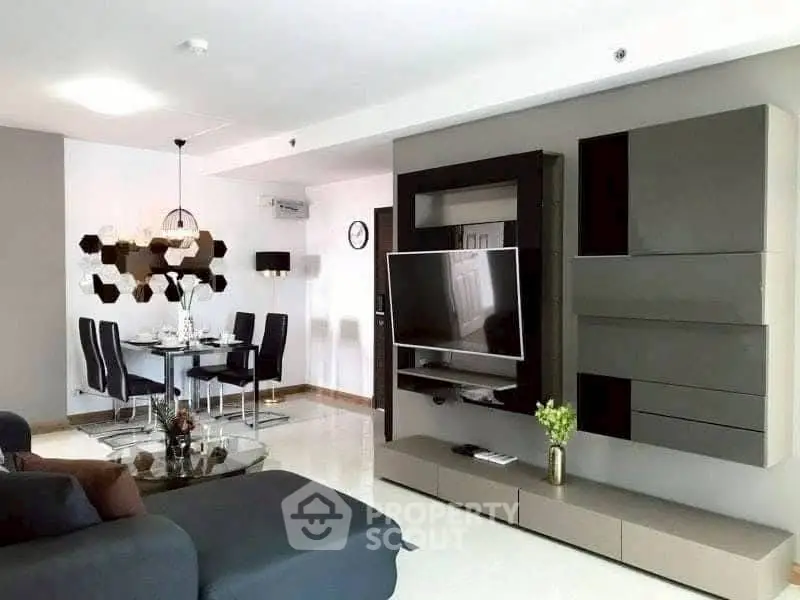 Modern living room with sleek TV unit and stylish dining area