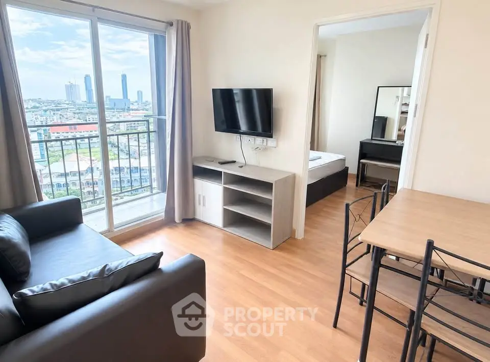 Modern apartment living room with city view, featuring sleek furniture and natural light.
