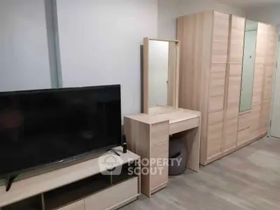 Modern bedroom with sleek wooden furniture and flat-screen TV