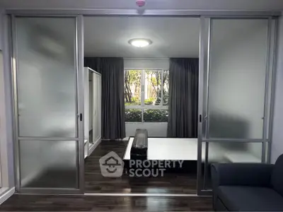 Modern bedroom with sliding glass doors and large window view