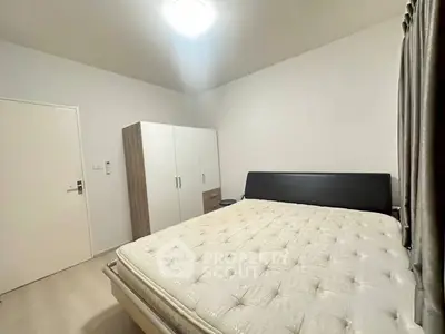 Spacious bedroom with modern furnishings and ample natural light.