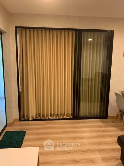 Modern living room with sliding glass door and elegant curtains