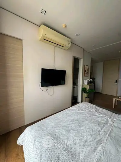 Modern bedroom with air conditioning and wall-mounted TV, featuring sleek design and cozy ambiance.