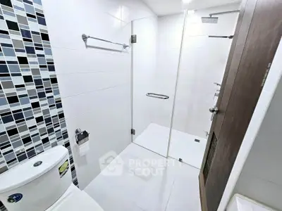 Modern bathroom with glass shower enclosure and stylish tile accents