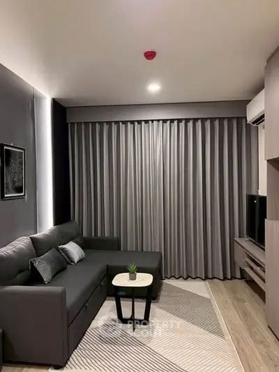 Modern living room with sleek gray sofa and stylish decor