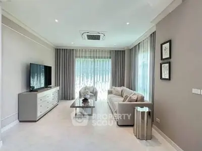 Elegant living room with modern decor and large windows for natural light.
