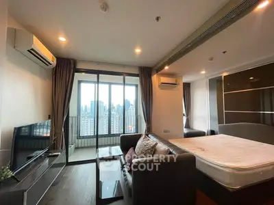 Modern living room with city view, featuring sleek furniture and large windows for natural light.