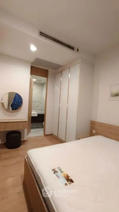 Modern bedroom with ensuite bathroom and stylish wooden furnishings