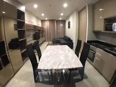 Modern open layout living room with sleek kitchen and elegant dining area