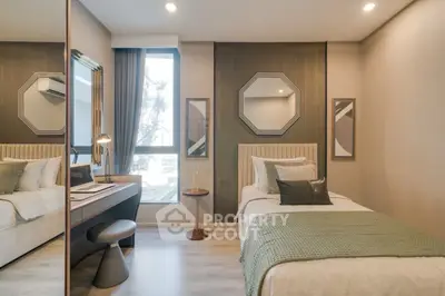 Modern bedroom with stylish decor and natural light, featuring a cozy single bed and workspace.