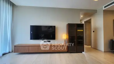 Modern living room with sleek TV setup and stylish wooden furniture