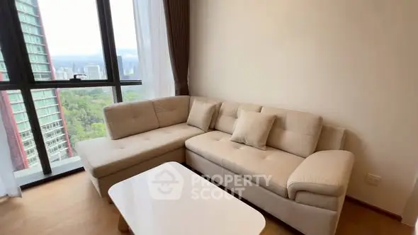 Bright living room with modern beige sectional sofa and stunning city view.