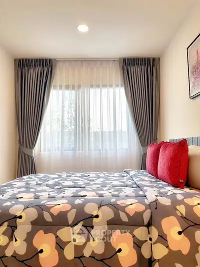 Cozy bedroom with floral bedding and elegant curtains, perfect for relaxation.
