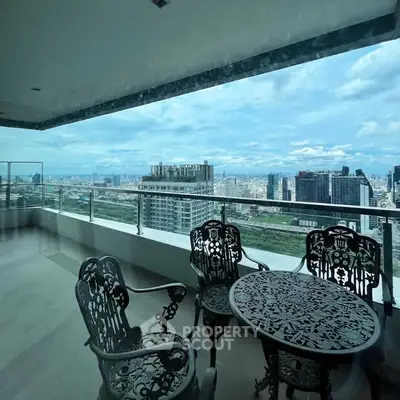 Luxurious balcony with stunning cityscape view and elegant outdoor furniture.