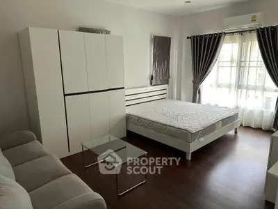 Spacious bedroom with modern furniture and natural light