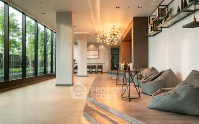 Spacious modern living area with large windows and stylish lighting