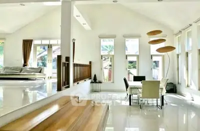 Spacious modern living room with dining area and abundant natural light