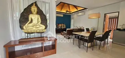 Elegant living and dining area with Buddha decor and modern furnishings